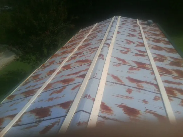 Rusted metal roof panels with new wood purlins before replacement — Storm Damage Roof Repair in Statesboro by Roofing Brothers